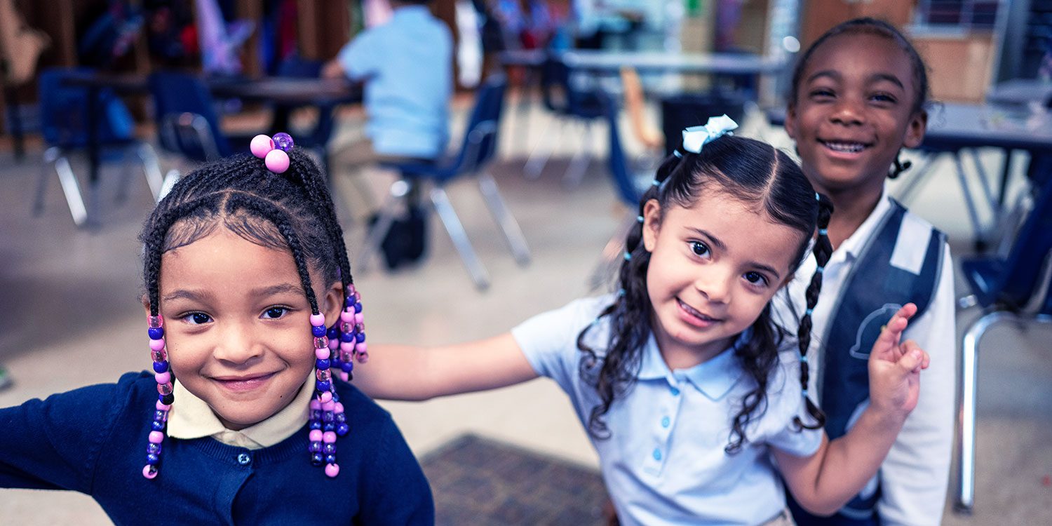 Group of smiling students in a classroom
