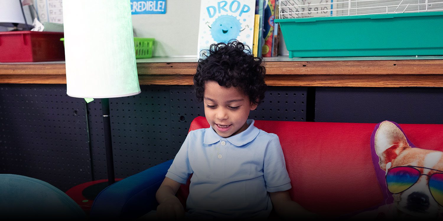 Student reading in a classroom
